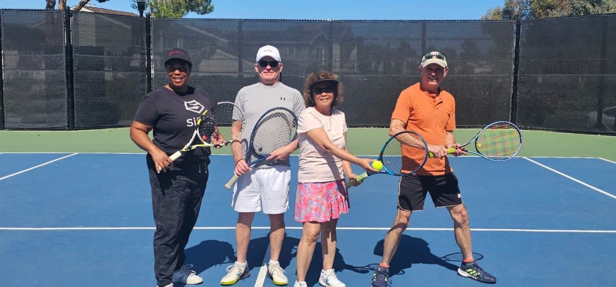 Four players crossing their rackets for the camera