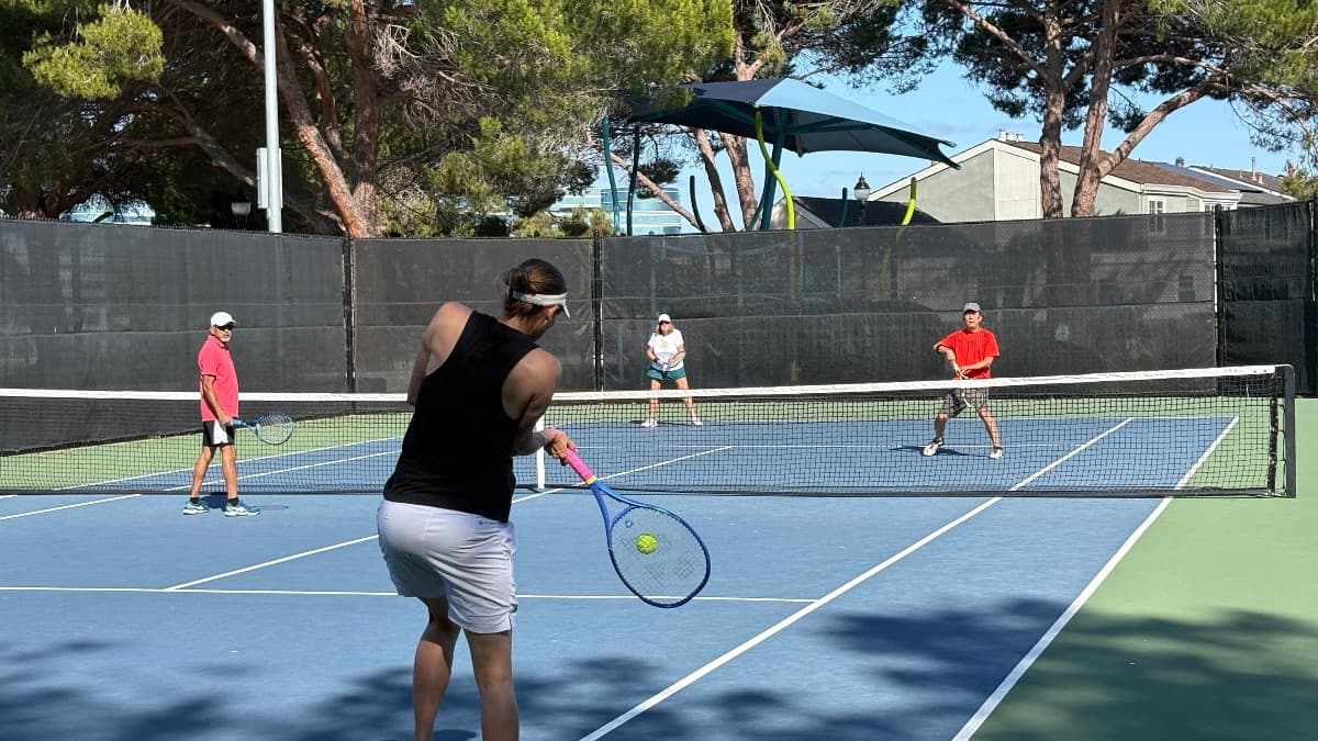 A doubles point in play, the ball meeting the racket